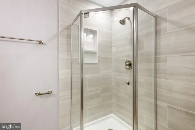 a bathroom with a glass shower door