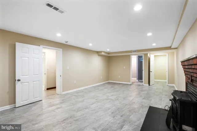 a view of an empty room with a fireplace