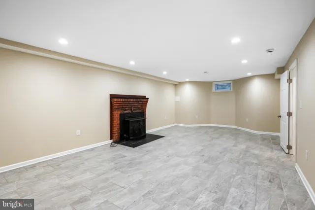 a view of an empty room with a fireplace