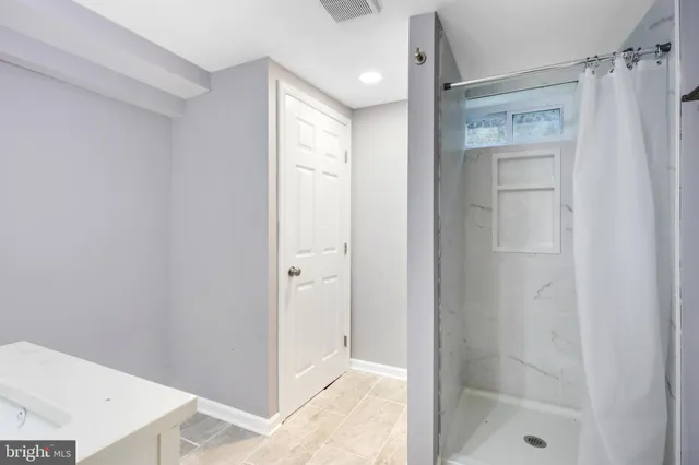 a bathroom with a shower and a sink