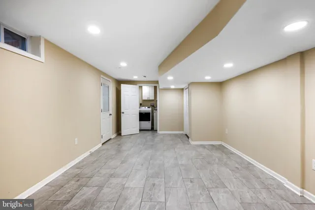 an empty room with wooden floor & door