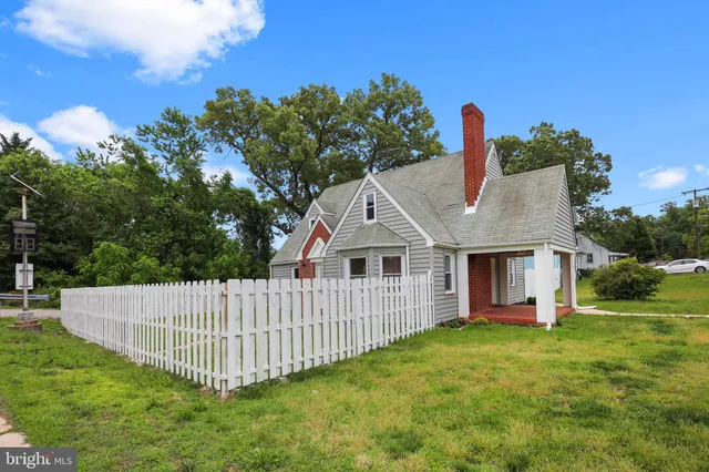 a view of a house with a yard and deck