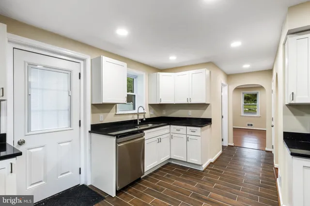a kitchen with granite countertop a stove and a sink