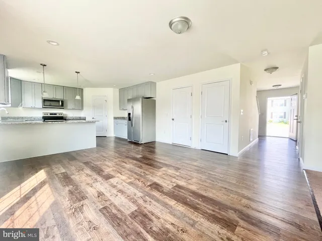 a view of a kitchen with a sink and dishwasher wooden floor