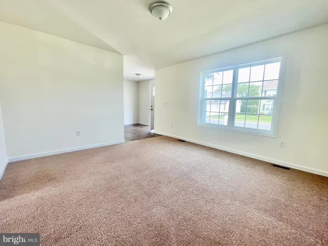 an empty room with a empty space and windows