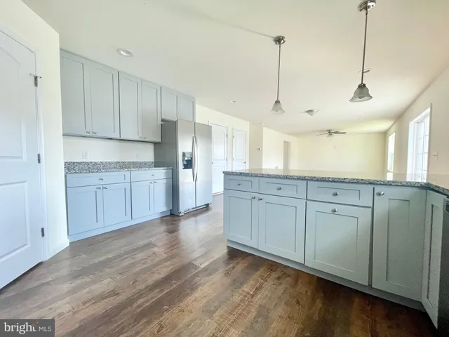 a view of a kitchen with wooden floor