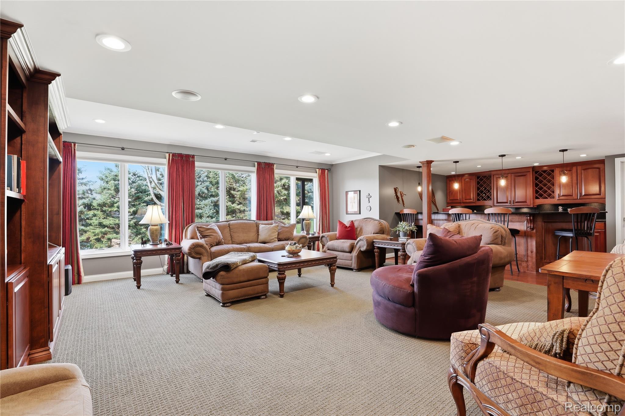 668 Springview Drive Rochester, MI 48307 - Photo 62 of 90 Living room with light colored carpet, plenty of natural light, recessed lighting, bar area, and decorative columns