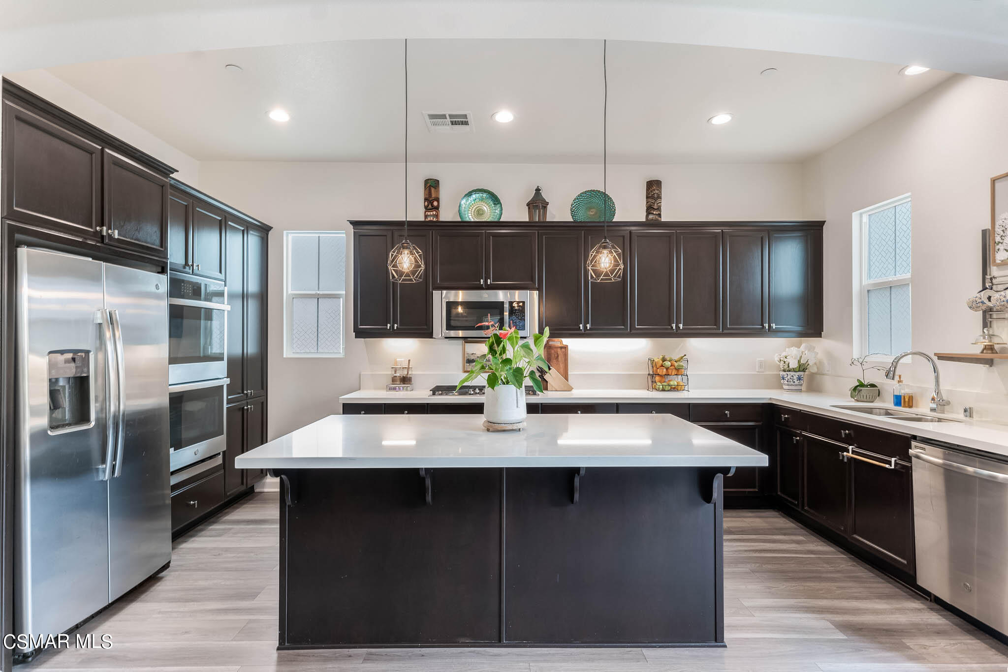a kitchen with a sink stainless steel appliances and cabinets