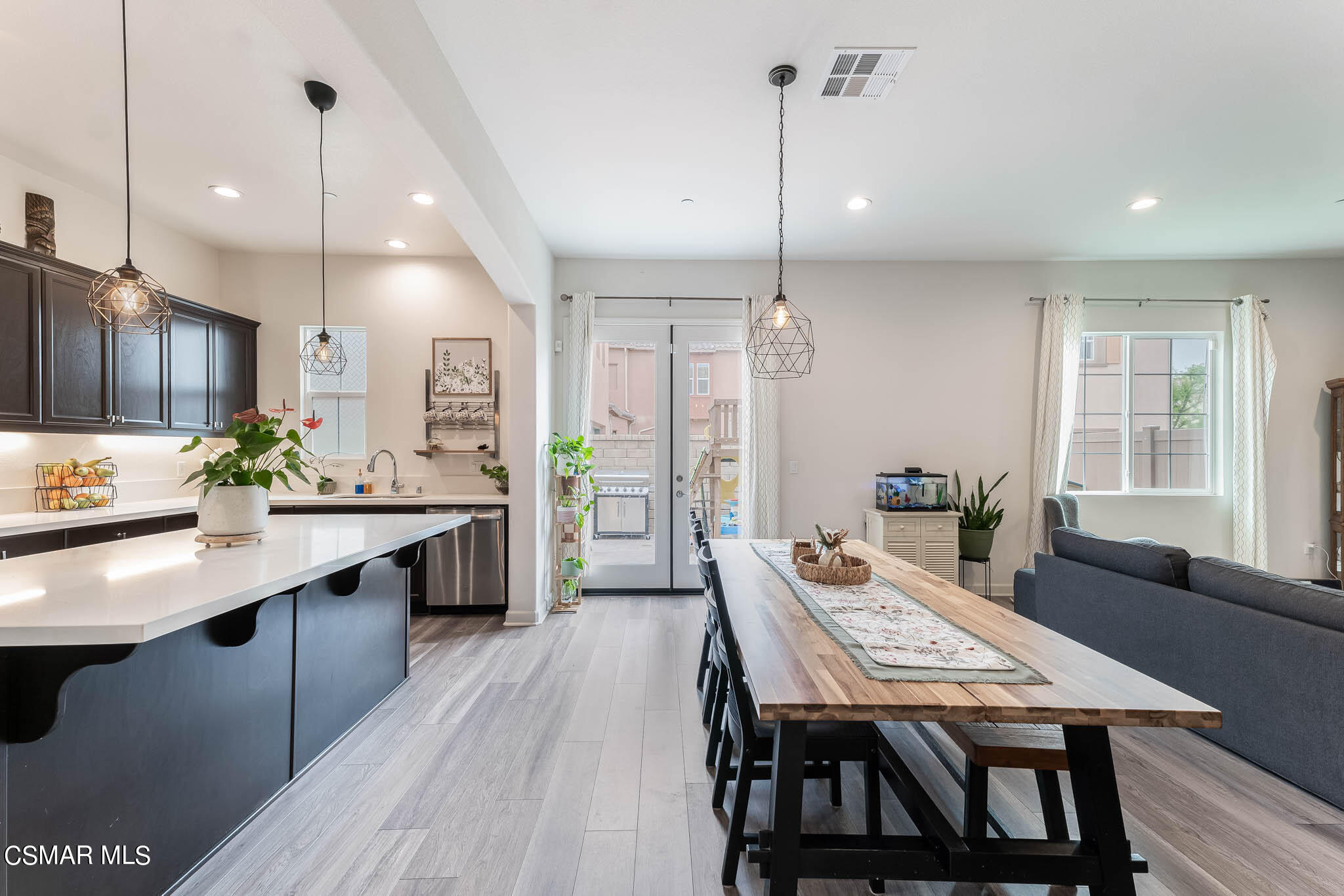 1622 Range Road Oxnard, CA 93036 - Photo 22 of 50 a kitchen with stainless steel appliances kitchen island granite countertop a table chairs stove and refrigerator