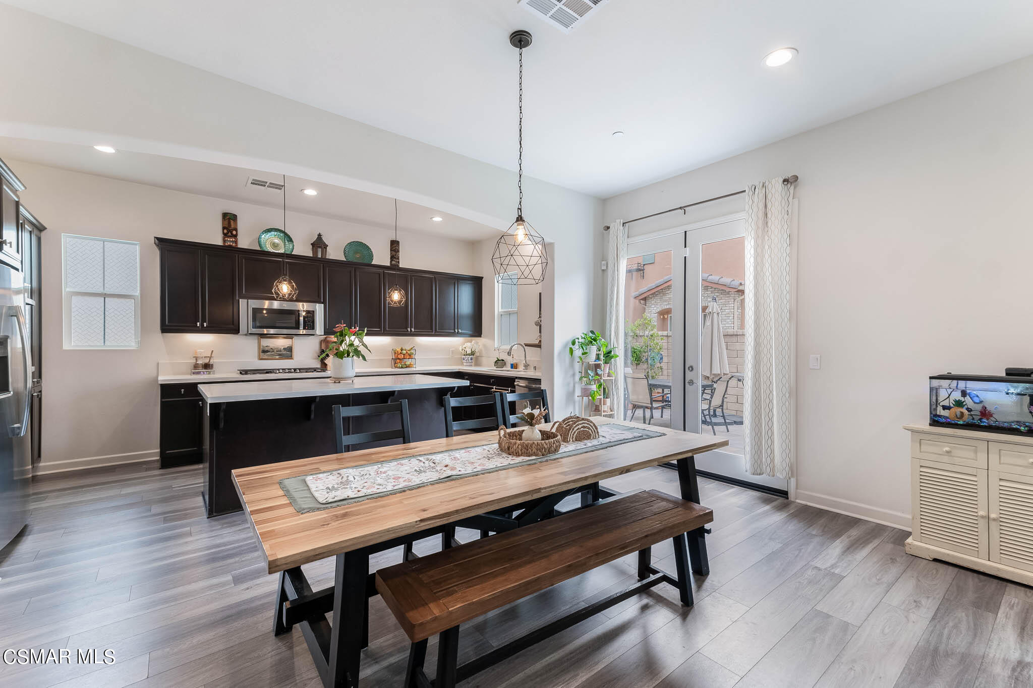 1622 Range Road Oxnard, CA 93036 - Photo 23 of 50 a living room with stainless steel appliances kitchen island granite countertop furniture and a wooden floor