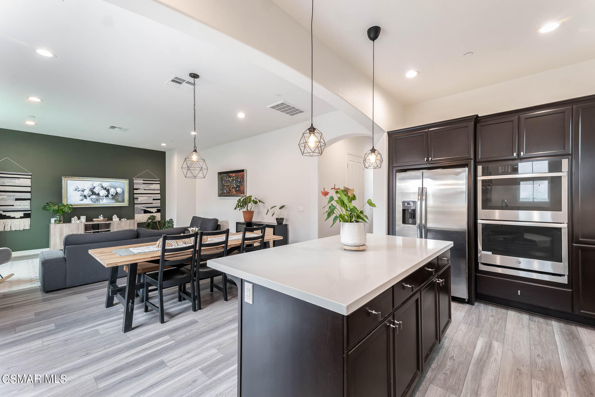 1622 Range Road Oxnard, CA 93036 - Photo 26 of 50 a kitchen with granite countertop a table chairs stainless steel appliances and wooden floor
