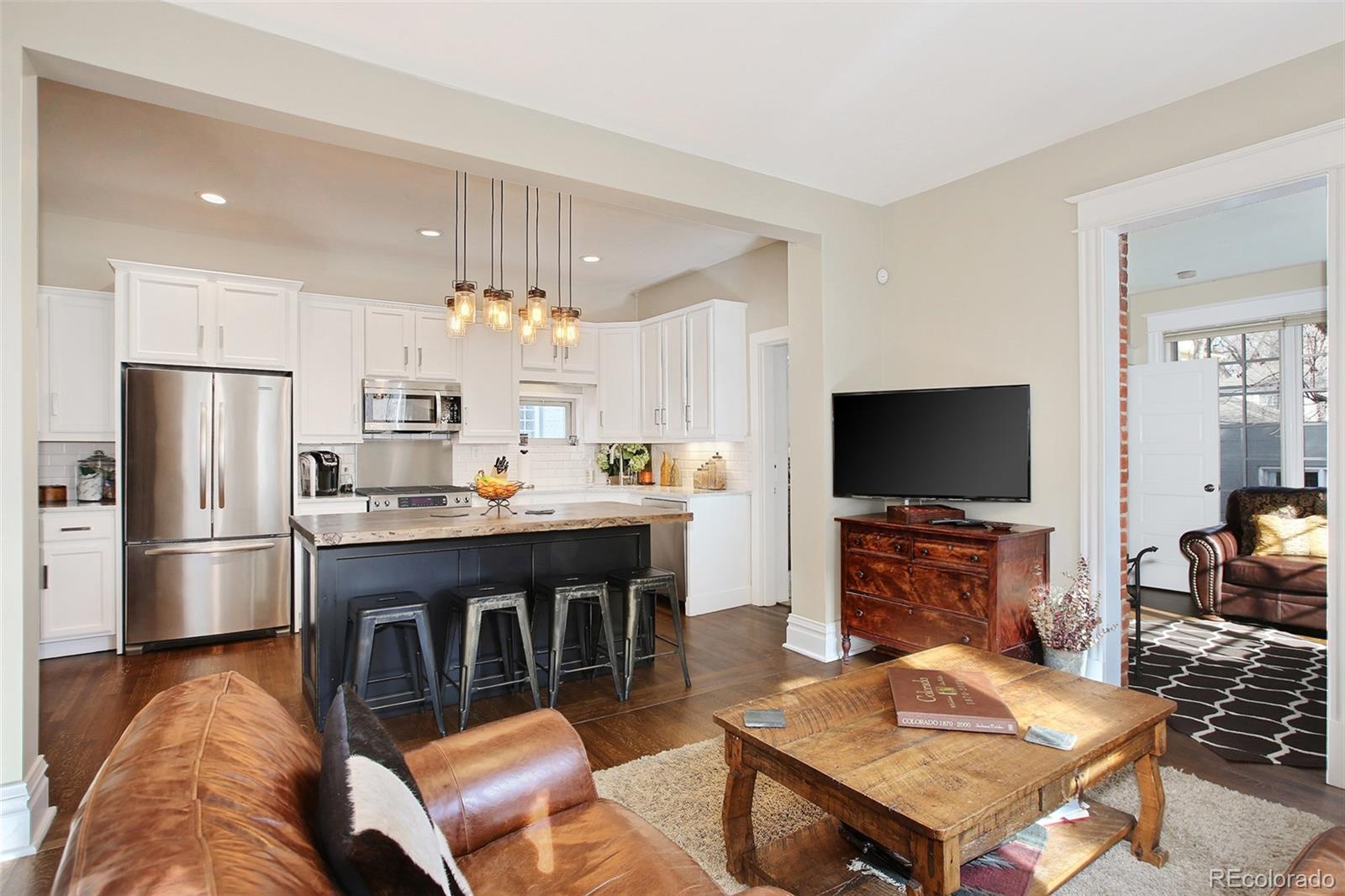 570 Gilpin Street Denver, CO 80218 - Photo 12 of 30 a living room with furniture a flat screen tv and kitchen view