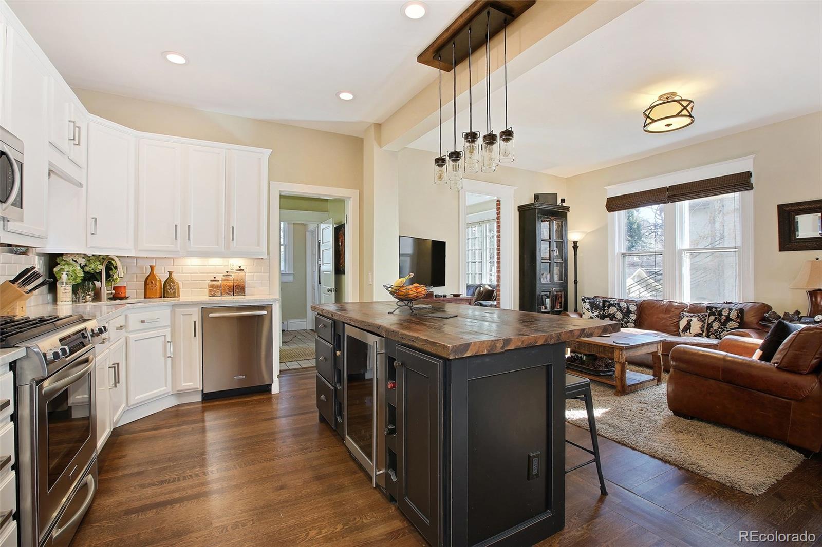 570 Gilpin Street Denver, CO 80218 - Photo 9 of 30 a kitchen with granite countertop lots of counter top space and stainless steel appliances
