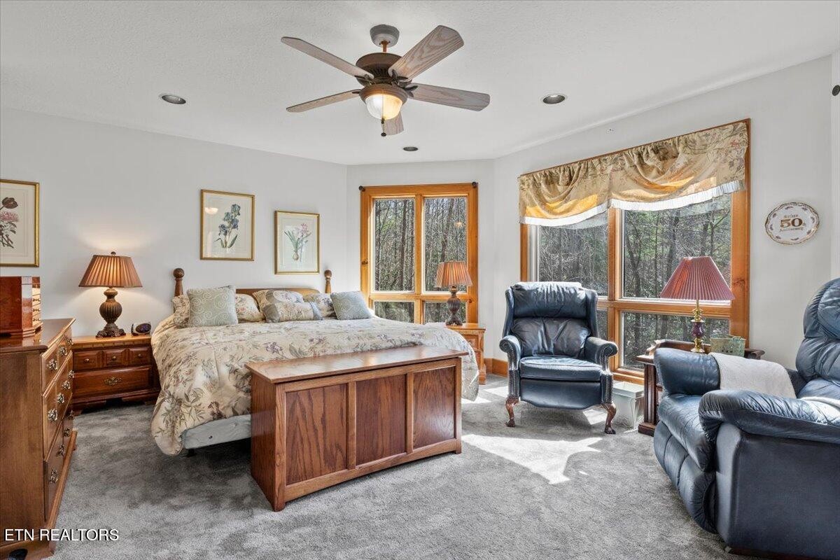 802 Stonegate Way Townsend, TN 37882 - Photo 18 of 44 a bedroom with a bed a couch and a large window