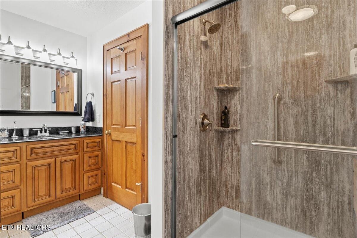 802 Stonegate Way Townsend, TN 37882 - Photo 22 of 44 a bathroom with a sink a mirror and a shower