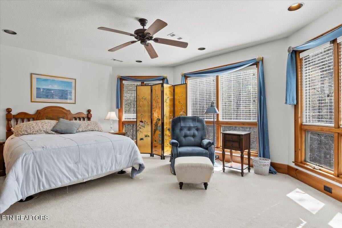 802 Stonegate Way Townsend, TN 37882 - Photo 27 of 44 a spacious bedroom with a bed couch and windows