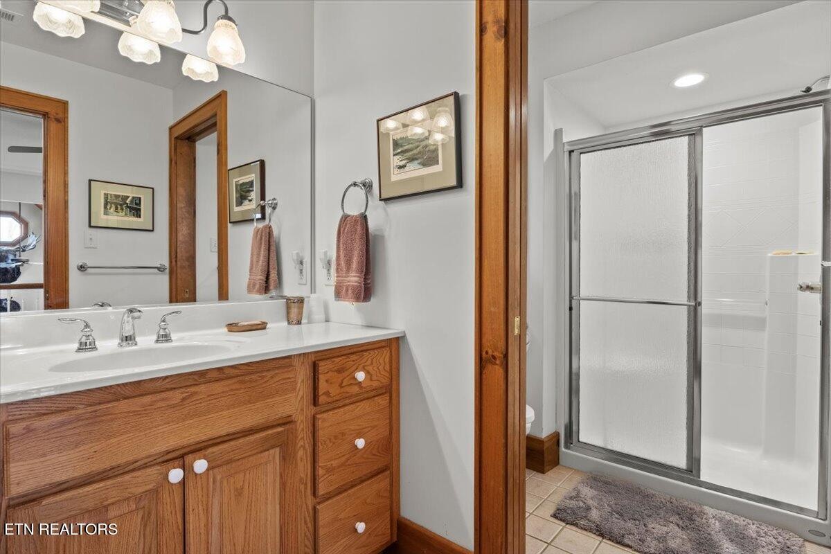 802 Stonegate Way Townsend, TN 37882 - Photo 30 of 44 a bathroom with a double vanity sink mirror and shower