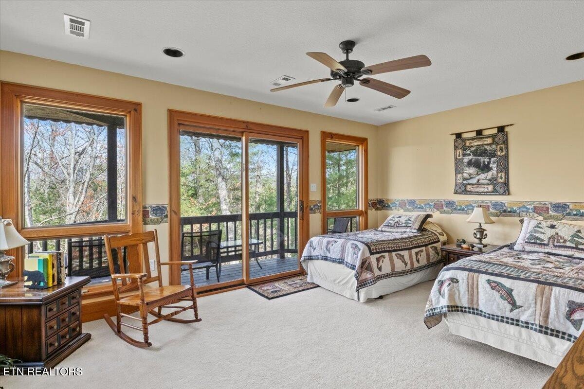 802 Stonegate Way Townsend, TN 37882 - Photo 31 of 44 a spacious bedroom with two beds and a large window