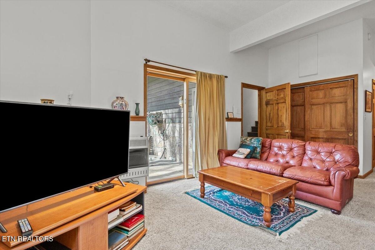 802 Stonegate Way Townsend, TN 37882 - Photo 37 of 44 a living room with furniture a flat screen tv and a window