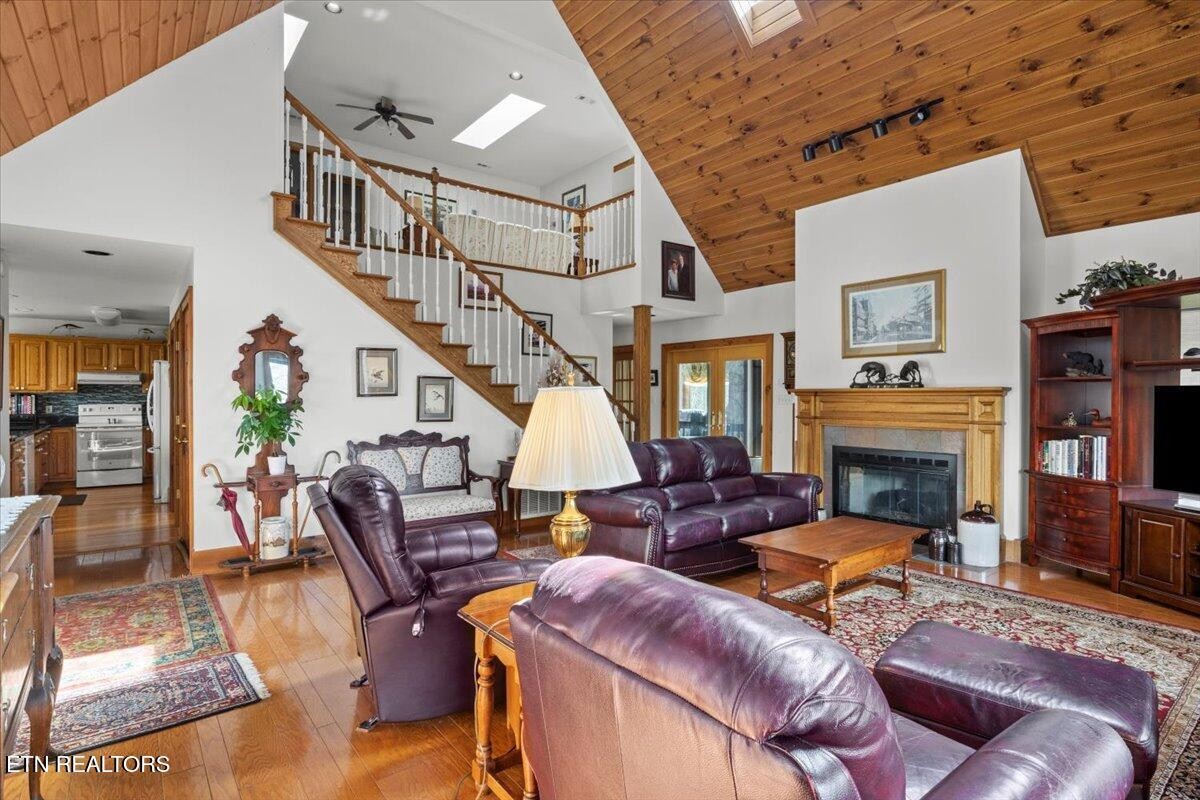 802 Stonegate Way Townsend, TN 37882 - Photo 9 of 44 a living room with furniture a fireplace and a flat screen tv
