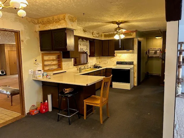 a kitchen that has a lot of cabinets and wooden floor