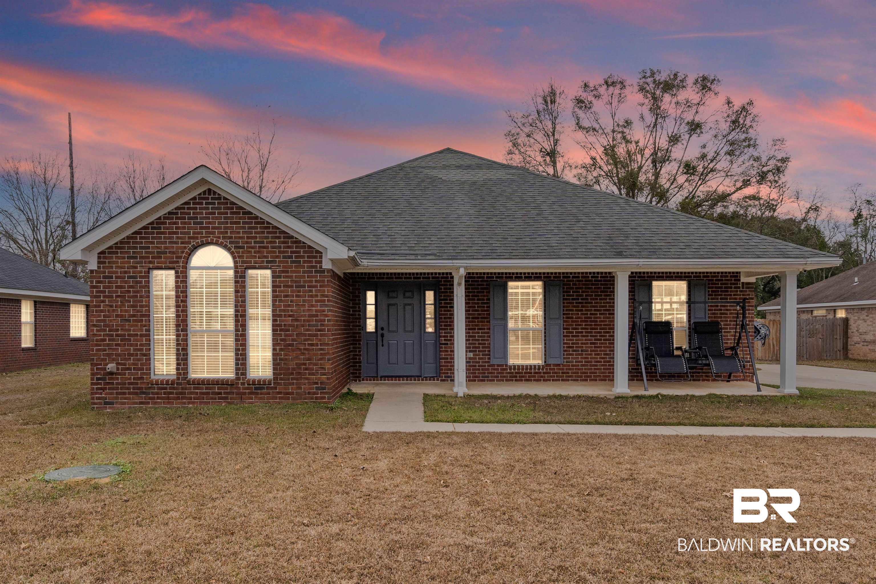 9590 Polo Pl Court Mobile, AL 36695 - Photo 1 of 22 Single story home featuring a porch, brick siding, a front lawn, and roof with shingles