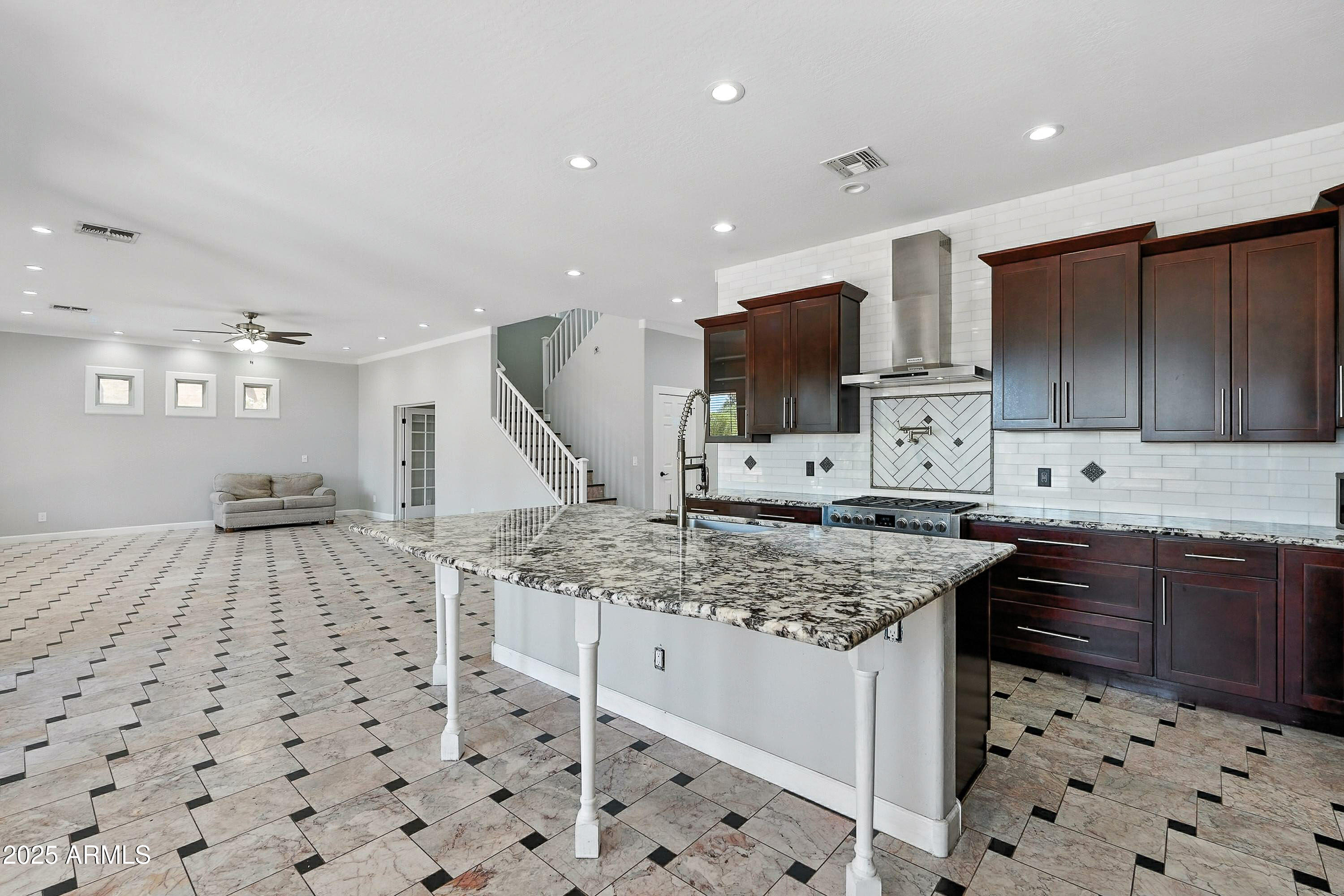 3042 South Seton Avenue Gilbert, AZ 85295 - Photo 8 of 71 a kitchen with stainless steel appliances kitchen island granite countertop a sink and cabinets