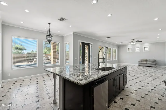a kitchen with stainless steel appliances kitchen island granite countertop a sink and cabinets
