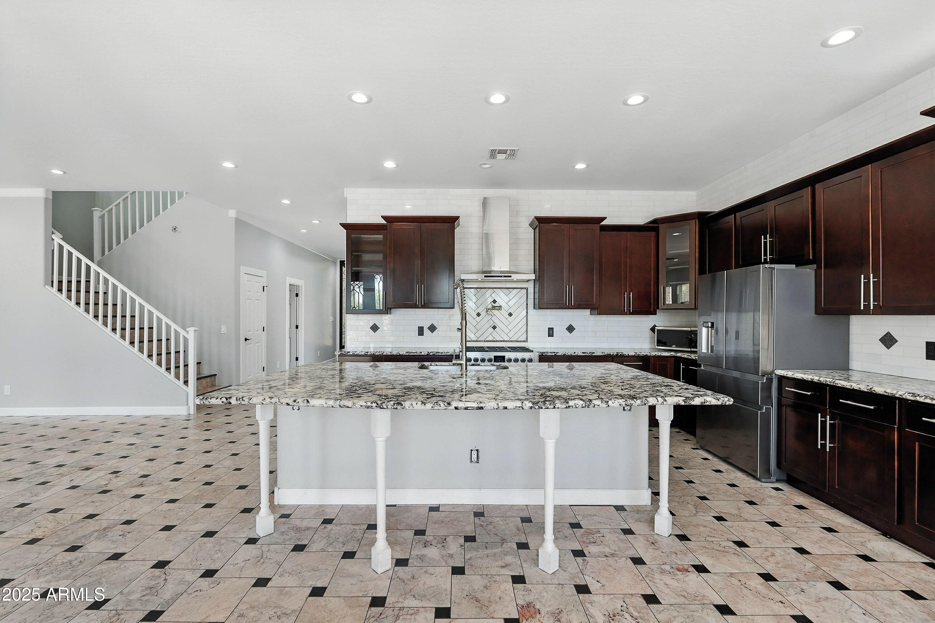 3042 South Seton Avenue Gilbert, AZ 85295 - Photo 10 of 71 a kitchen with stainless steel appliances kitchen island granite countertop a sink and cabinets