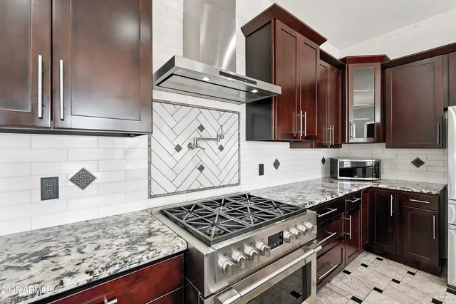 a kitchen with granite countertop a sink and a window