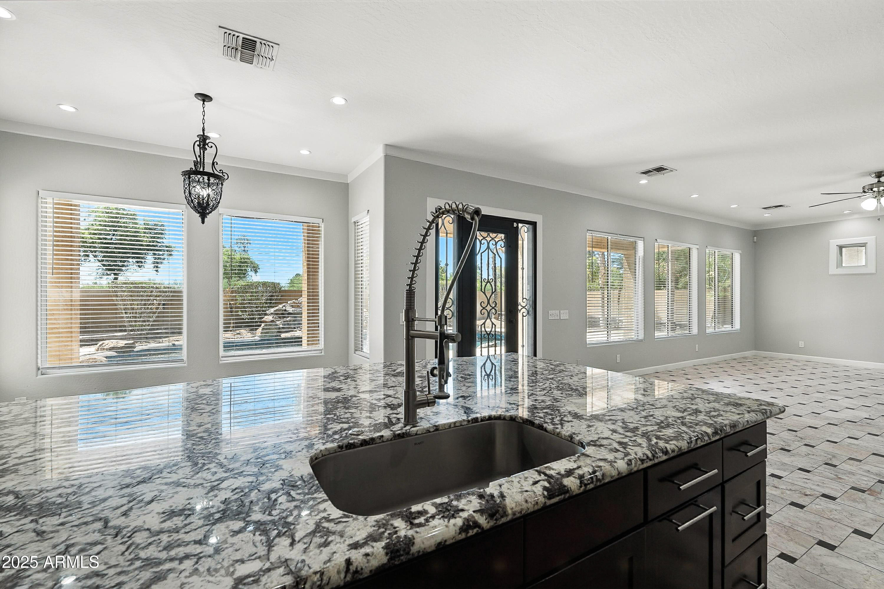 3042 South Seton Avenue Gilbert, AZ 85295 - Photo 13 of 71 a kitchen with granite countertop a sink and a window