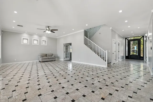 a view of a livingroom with a dinning space and windows