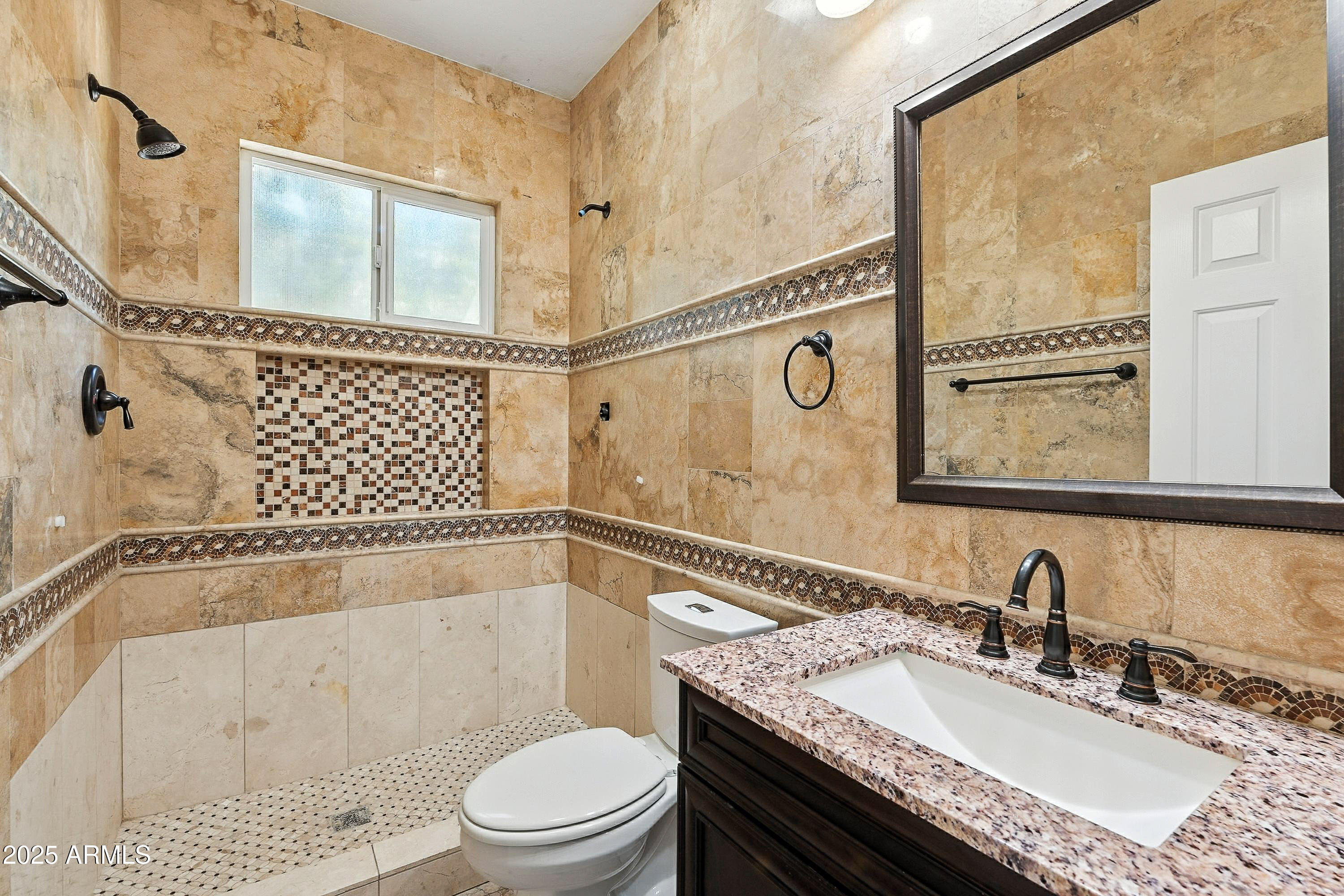 3042 South Seton Avenue Gilbert, AZ 85295 - Photo 27 of 71 a bathroom with a granite countertop sink a mirror and a bathtub