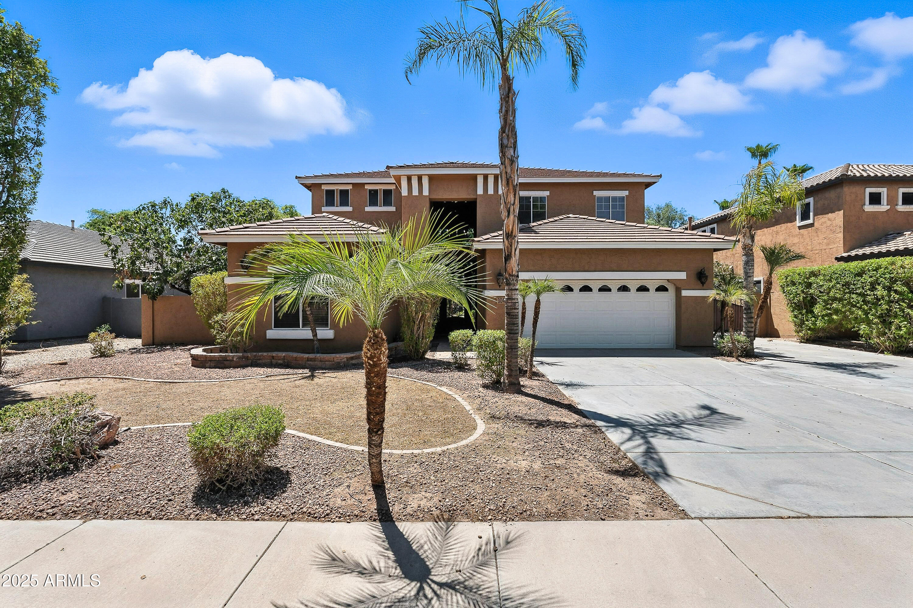 3042 South Seton Avenue Gilbert, AZ 85295 - Photo 2 of 71 a front view of a house with garden