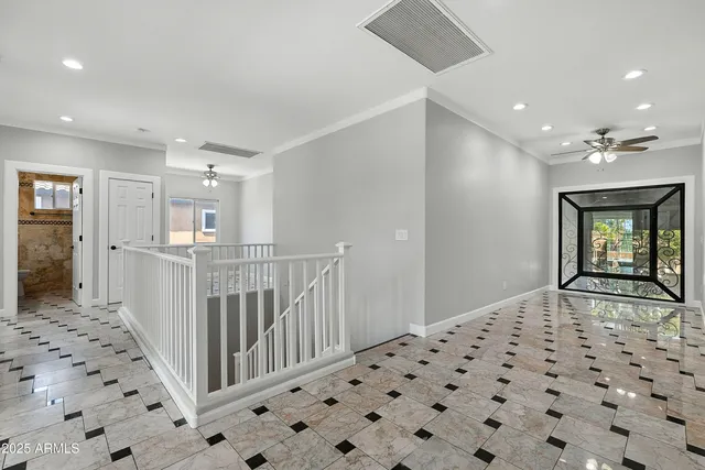 a view of an empty room with a ceiling fan