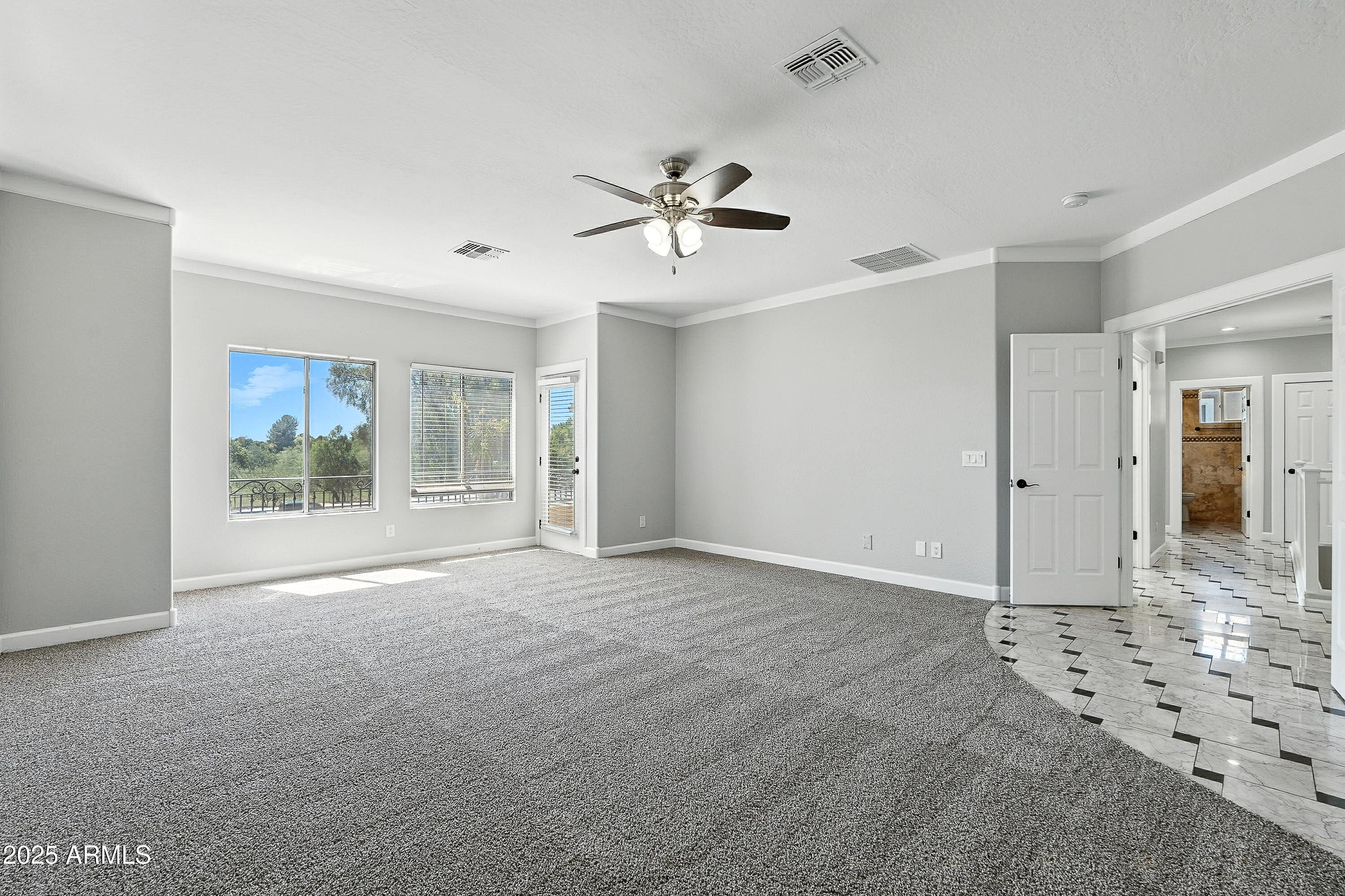 3042 South Seton Avenue Gilbert, AZ 85295 - Photo 32 of 71 a view of a livingroom with a chandelier fan and windows