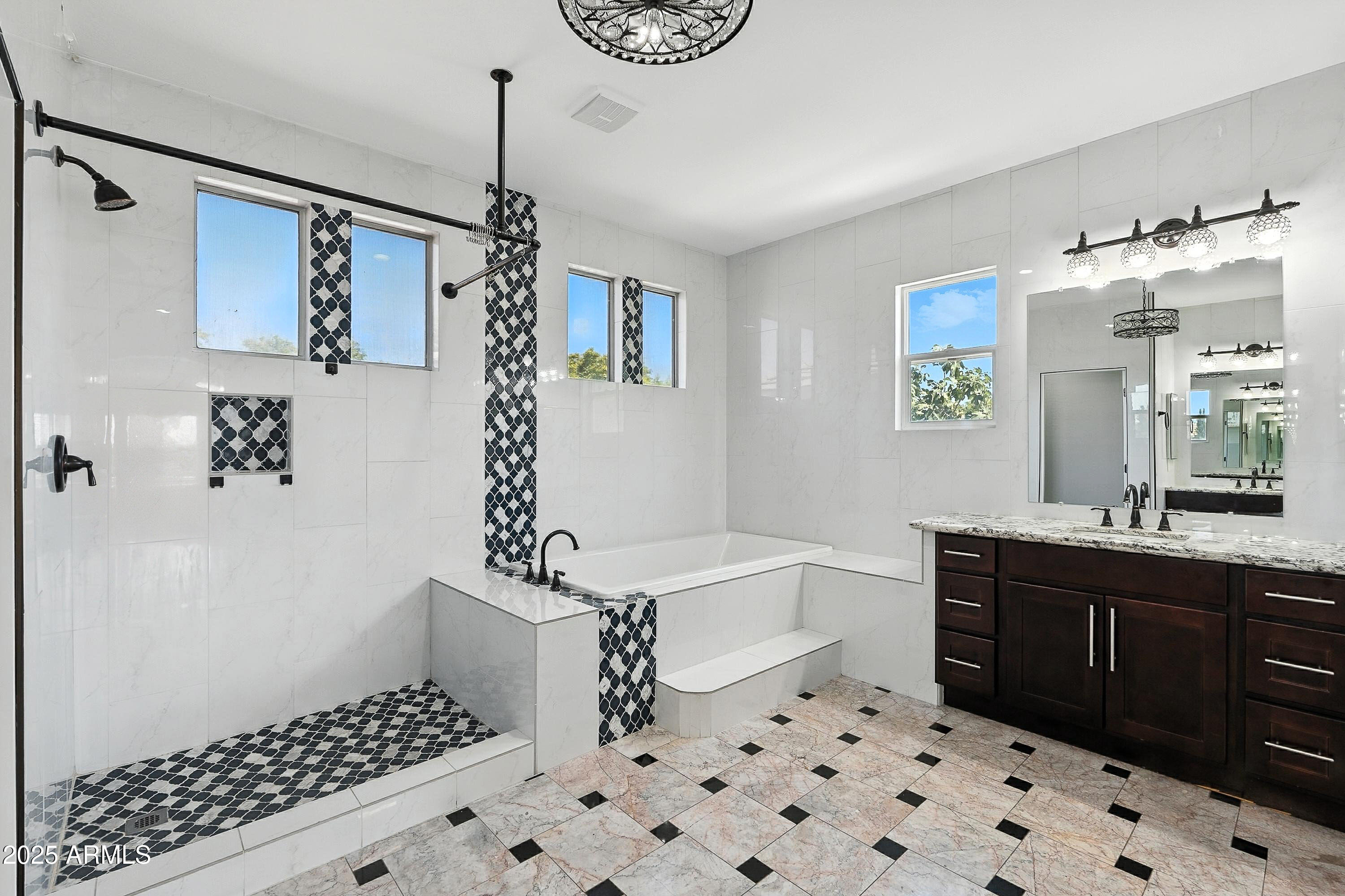 3042 South Seton Avenue Gilbert, AZ 85295 - Photo 35 of 71 a bathroom with a sink a mirror and a shower