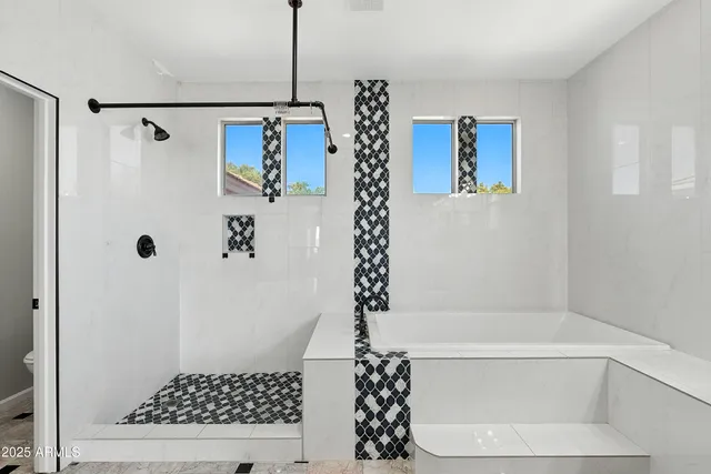 en empty room with chandelier fan