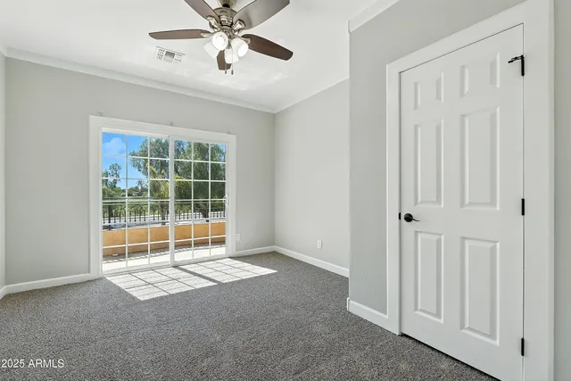 a view of a hallway to a bedroom with a window
