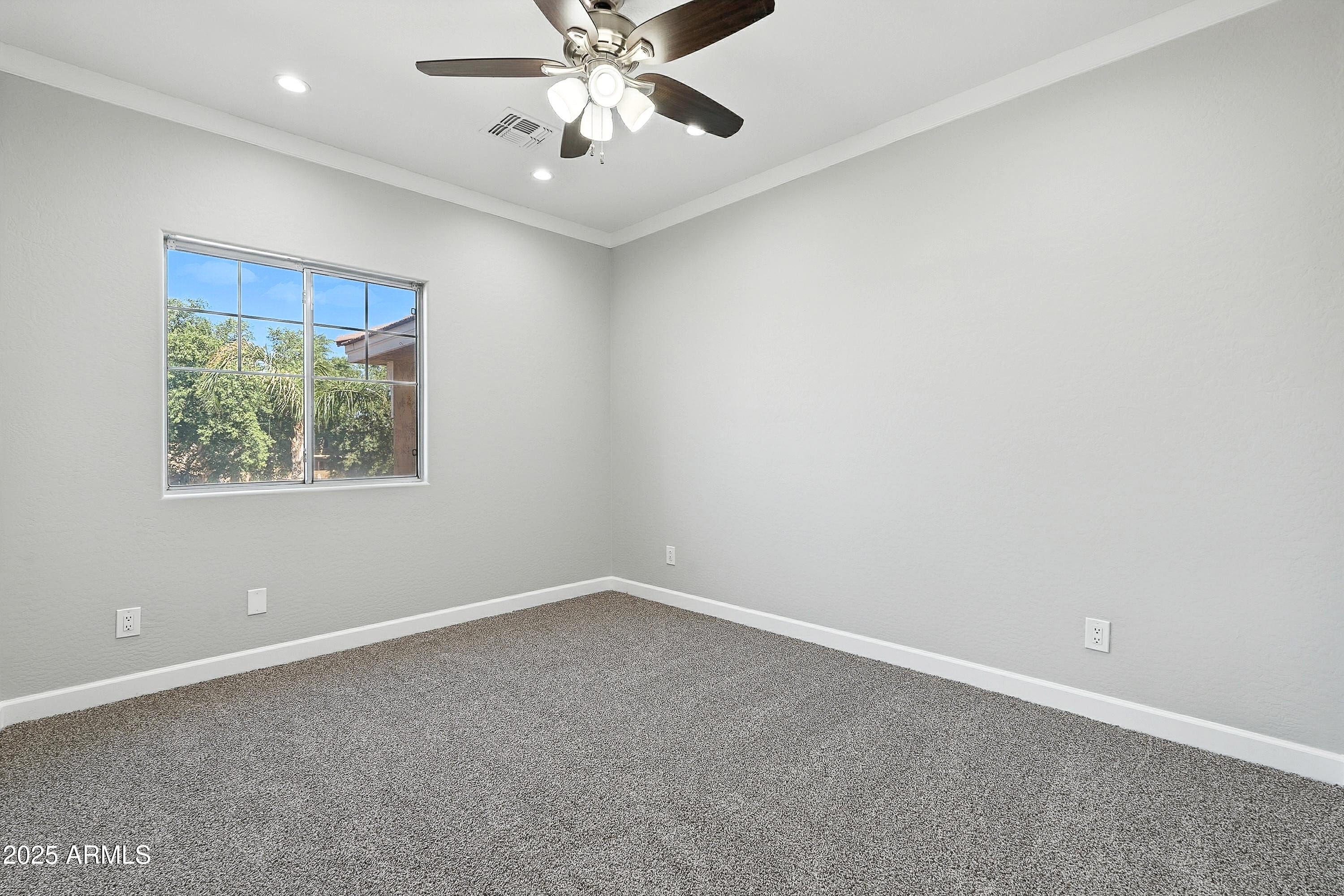 3042 South Seton Avenue Gilbert, AZ 85295 - Photo 46 of 71 an empty room with a window and a fan