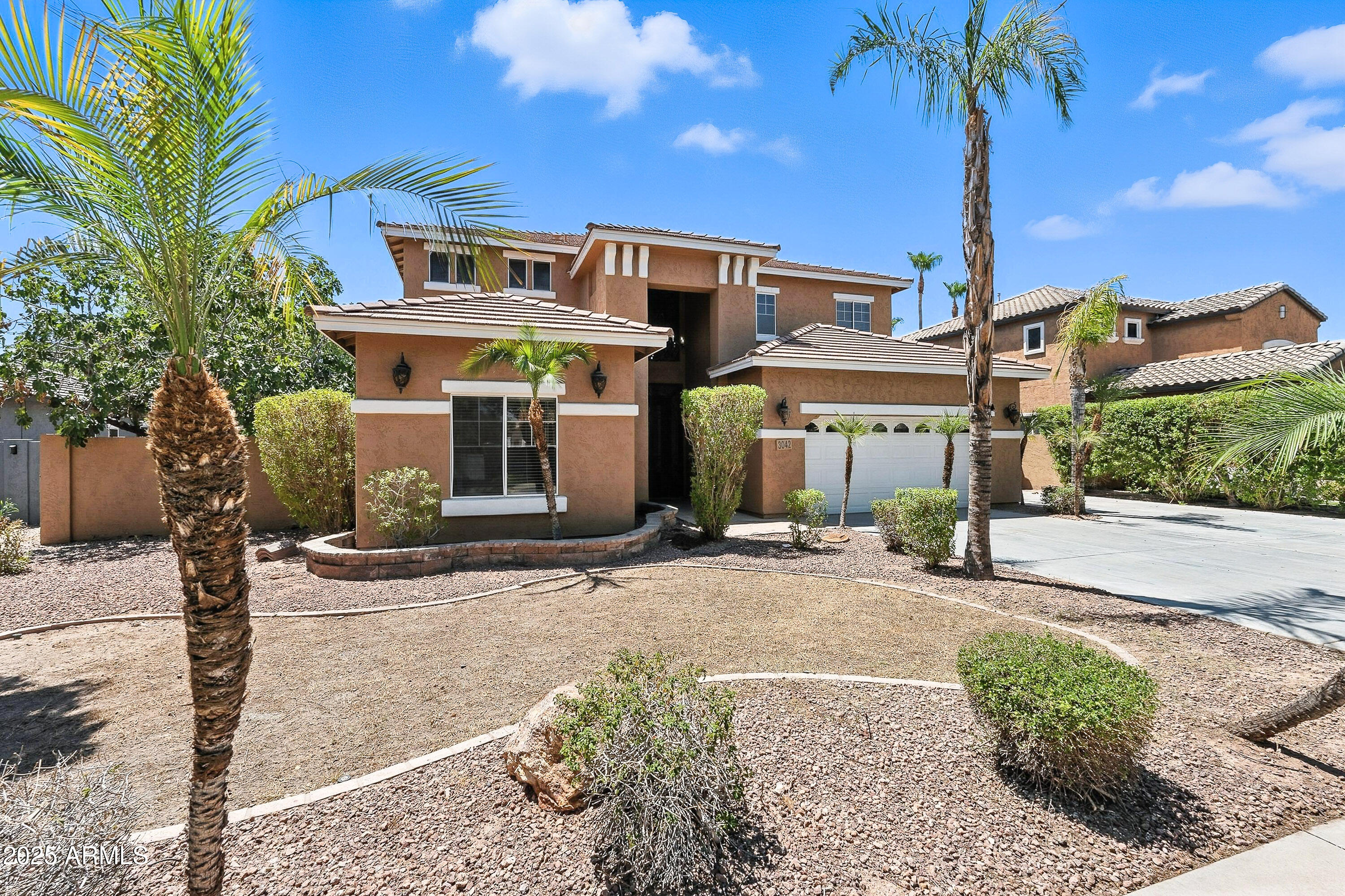 3042 South Seton Avenue Gilbert, AZ 85295 - Photo 3 of 71 a front view of a house with garden