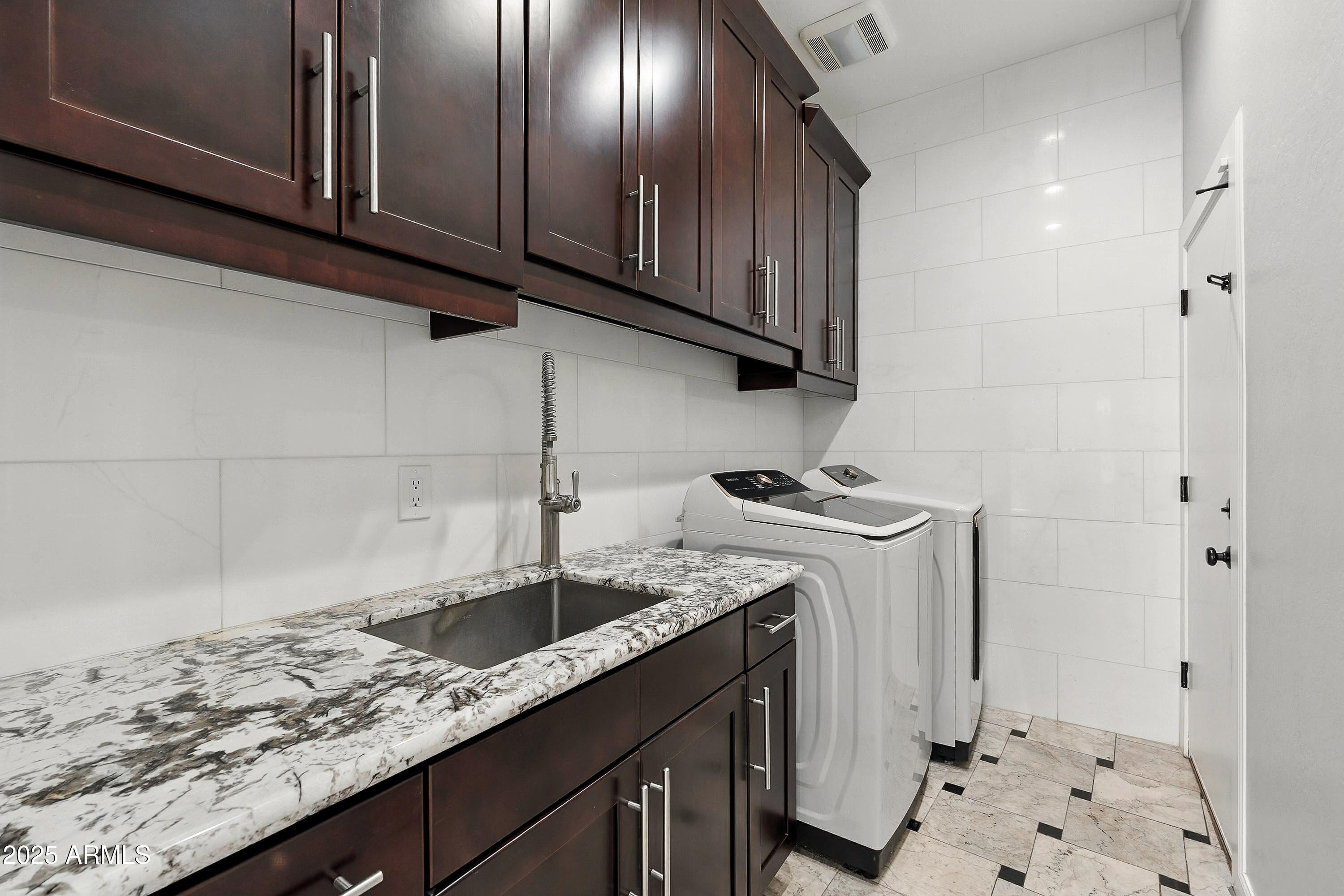 3042 South Seton Avenue Gilbert, AZ 85295 - Photo 53 of 71 a kitchen with a sink and cabinets