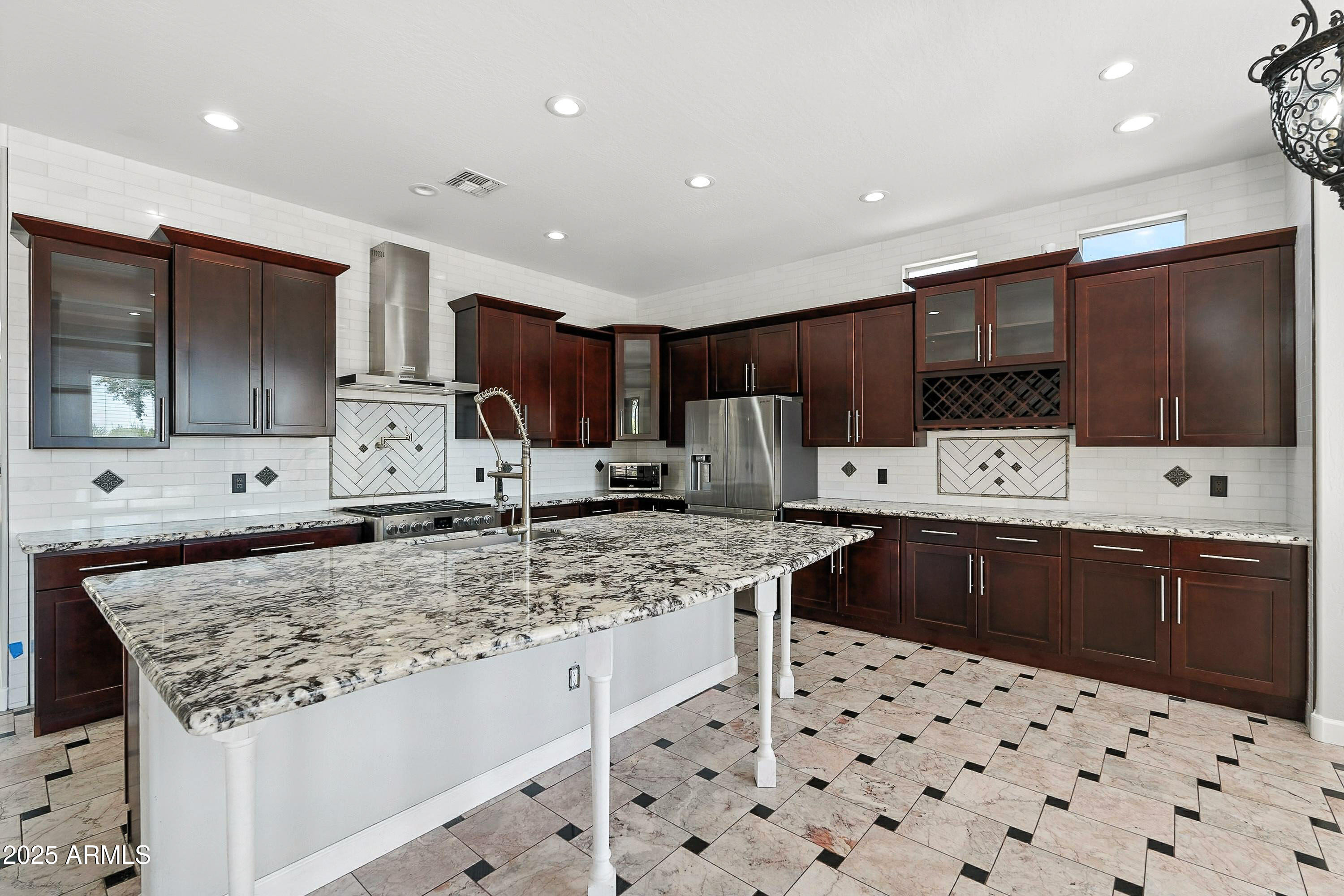 3042 South Seton Avenue Gilbert, AZ 85295 - Photo 7 of 71 a kitchen with stainless steel appliances kitchen island granite countertop a sink and cabinets