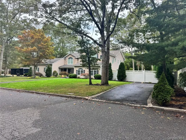 a house with green field in front of it