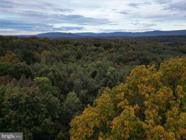 an aerial view of a house with mountain view