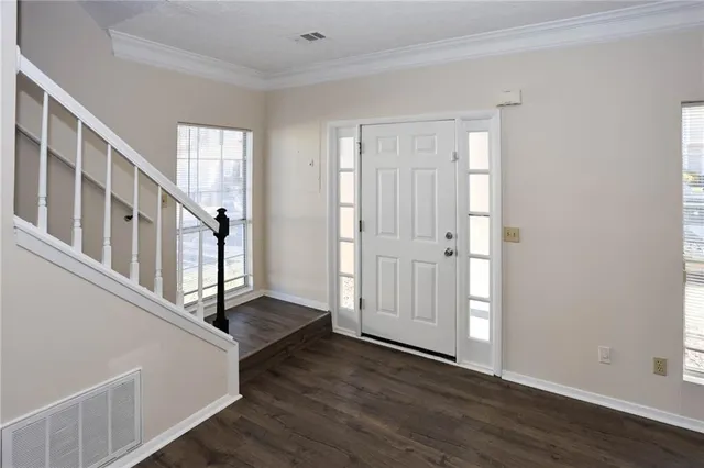a view of an entryway with wooden floor