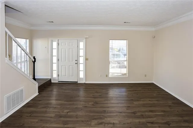 an empty room with a window and a ceiling fan