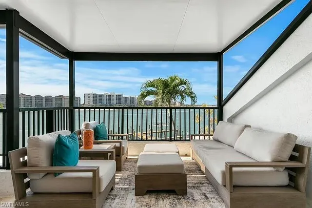 a balcony with furniture and a potted plant