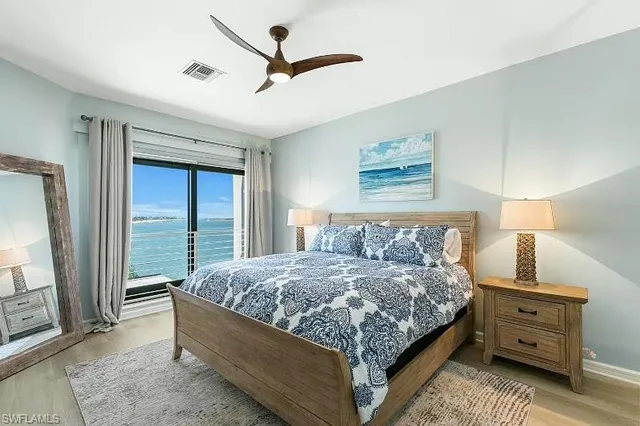 a bedroom with a large bed and a window