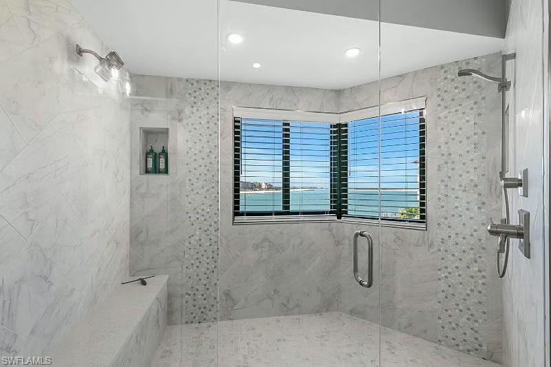 310 La Peninsula Boulevard, Unit 310 Naples, FL 34113 - Photo 17 of 27 a bathroom with a shower and a shower